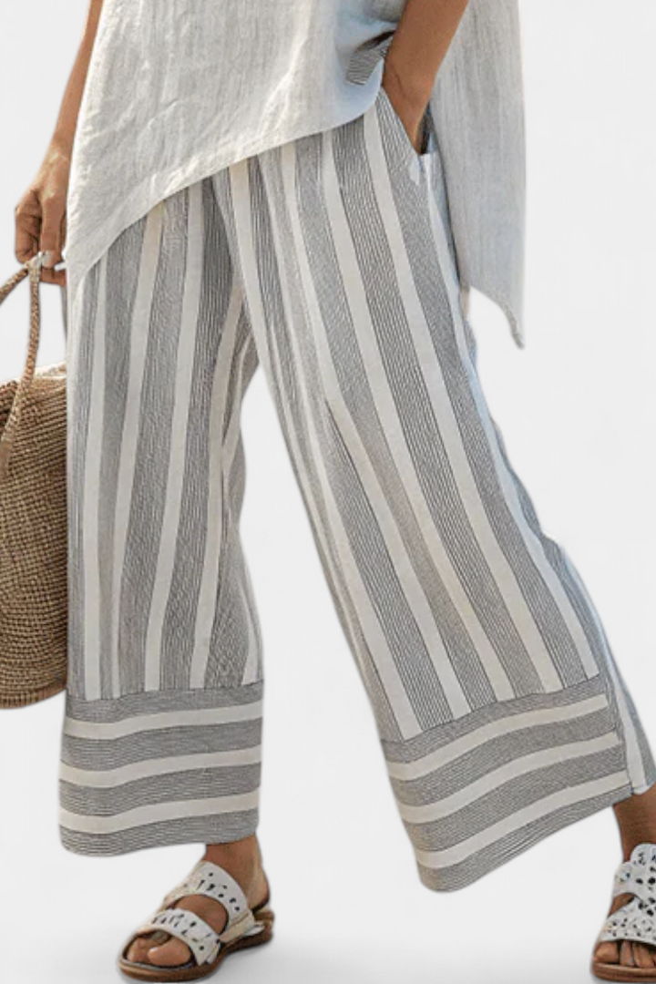 Completo Daisy di Blusa Asimmetrica e Pantaloni a Righe per uno Stile Moderno ed Elegante